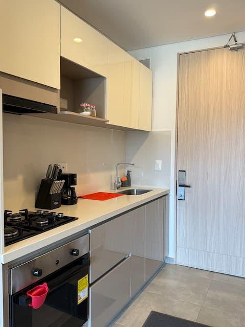 Cocina moderna equipada con electrodomésticos y gabinetes de madera en premium suite Santa Marta