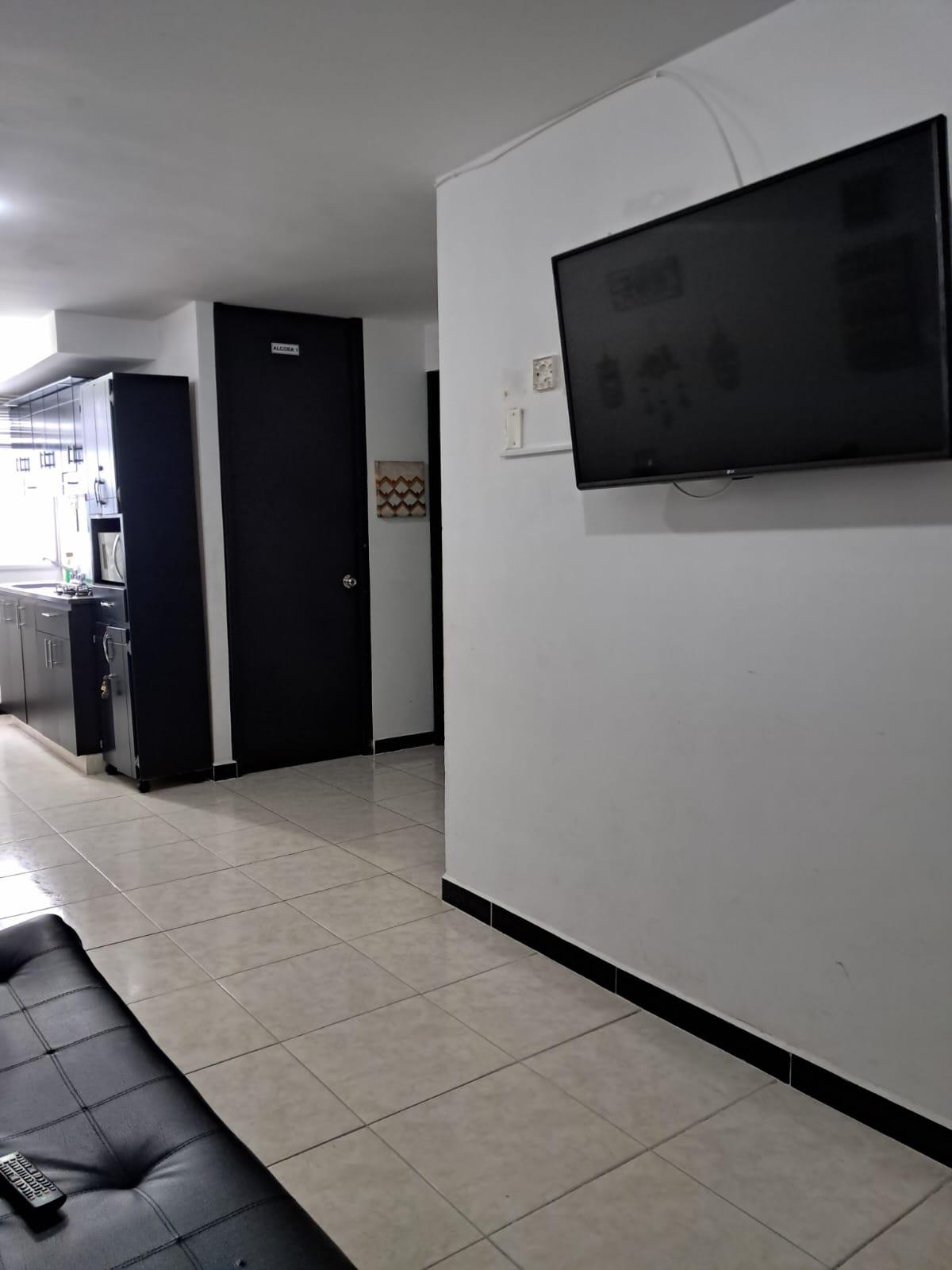 Sala de estar moderna con televisión de pantalla plana en apartamento Montenegro cerca Parque del Café