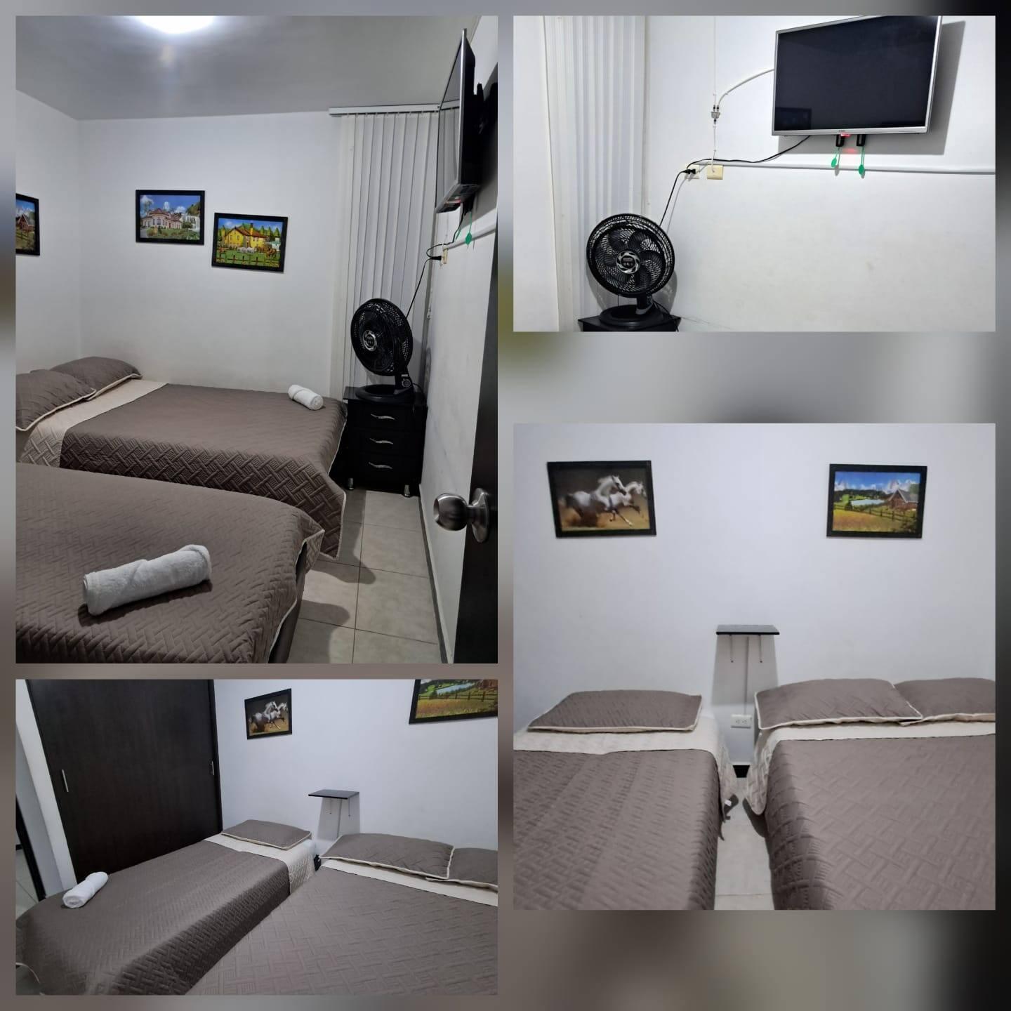 Habitación doble con dos camas individuales y televisor en apartamento Montenegro cerca Parque del Café