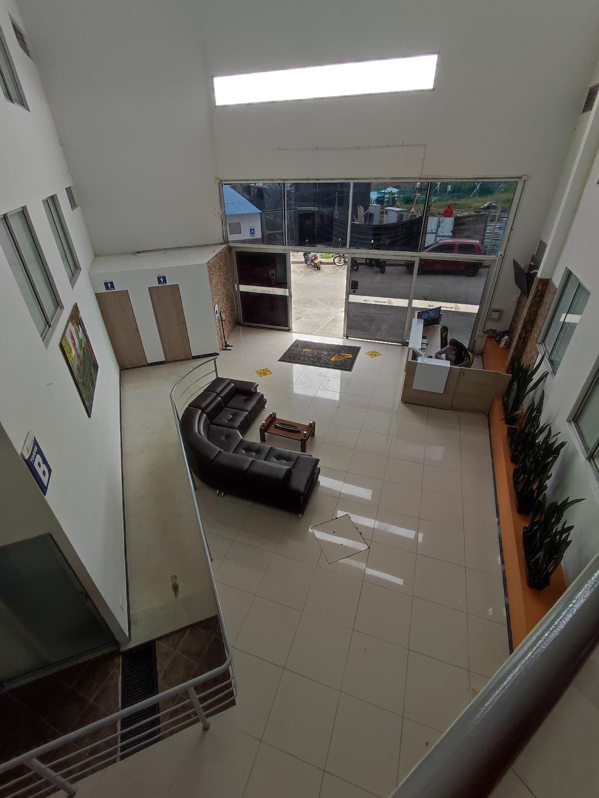 Lobby moderno con sofás negros y amplia entrada de apartamento vacacional en Montenegro